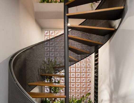 Escada metálica helicoidal com design exclusivo em ambiente sofisticado - a arte em aço da HBFER Estruturas Metálicas